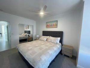 a bedroom with a bed and a ceiling fan at Coastal Calm Seascapes unit 2 in Falcon +15 photos