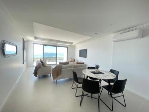 a living room with a couch and a table and chairs at Coastal Calm Seascapes unit 2 in Falcon