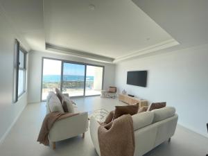 a living room with two couches and a television at Coastal Calm Seascapes unit 2 in Falcon