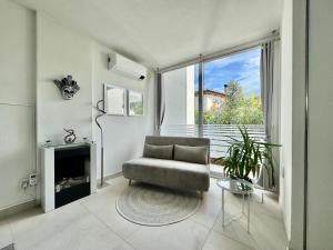 a living room with a chair and a fireplace at Villa 124 Residence in Lignano Sabbiadoro
