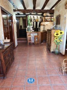 a large kitchen with a tile floor and a counter at Hotel Rural Papasol in Atapuerca +5 photos