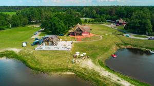 an aerial view of a house on an island in the water at Svencelė Resort in Svencelė +19 photos
