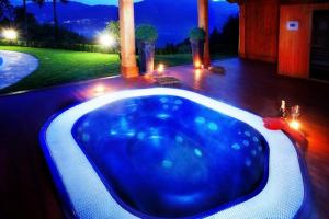 a large blue tub in a backyard at night at Tremezzo Residence in Tremezzo