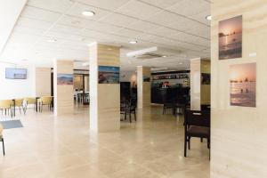 a dining room with chairs and tables in a building at BLUESEA Paraiso Beach - Adults Only in Es Cana