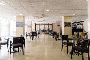 a dining room with tables and chairs in a building at BLUESEA Paraiso Beach - Adults Only in Es Cana