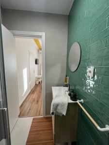 a green bathroom with a sink and a mirror at Casa do Ti Luís in Leiria +71 photos
