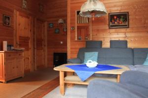 a living room with a couch and a table at Ferienhaus-Kuenzel in Viechtach +6 photos
