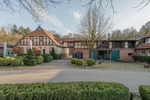 an exterior view of a house with a driveway at Klostermühle in Groß Meckelsen