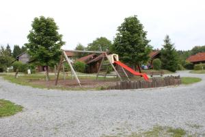 a playground with a slide in a park at Ferienhaus-Kuenzel in Viechtach