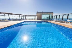 a swimming pool on the roof of a building at BLUESEA Calabahía in Cala del Moral