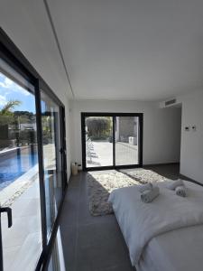 a bedroom with a bed and a view of a pool at Moraira B5 in Moraira +25 photos