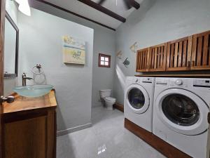 a bathroom with a washing machine and a sink at Vacation Home in Pedasí Town