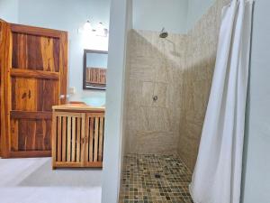 a bathroom with a shower and a sink at Vacation Home in Pedasí Town +18 photos