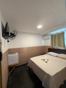 a bedroom with a bed and a fan on the wall at Hotel Bela Vista in Salvador +47 photos