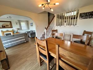 a dining room and living room with a table and chairs at Looe, Cornwall, couples, families, quiet location, views, reliable Wi-Fi, 3 bed LANGUNNETT COTTAGE in Looe