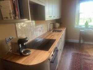 a kitchen with a counter with a coffee maker on it at Barns Studio in Peebles +11 photos