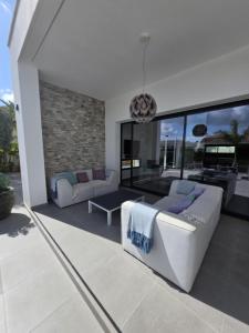 a living room with two couches and a table at Moraira B5 in Moraira