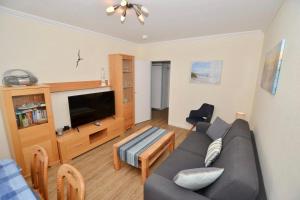 a living room with a couch and a tv at Appartement-124 in Westerland