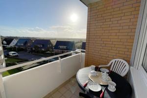 a table and chairs on a balcony with a view at Appartement-162 in Westerland