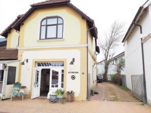 a yellow and white house with a door at Haus-Bockelmann in Westerland