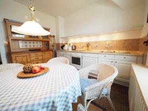 a kitchen with a table with a bowl of fruit on it at Haus-Bockelmann in Westerland