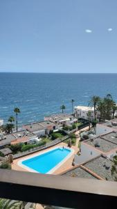 a view of a swimming pool next to the ocean at Sun and ocean in San Bartolomé