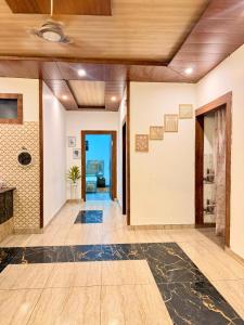 a hallway of a home with wood ceilings at Luxury Palm Stay in Jammu