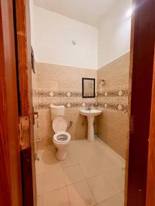 a bathroom with a toilet and a sink at Luxury Palm Stay in Jammu