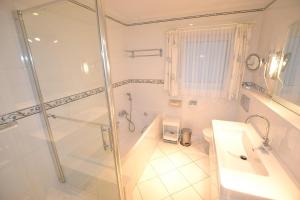 a bathroom with a shower and a sink and a toilet at Haus-Neumann in Westerland +8 photos