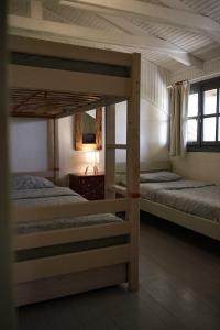 a bedroom with two bunk beds and a mirror at Nectar Cottages in Varákkes