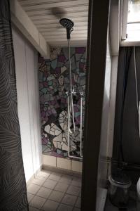 a bathroom with a mosaic tile wall and a shower at Nectar Cottages in Varákkes +33 photos