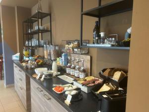 a buffet with food on a counter in a kitchen at Ostello Del Porto in Lovere