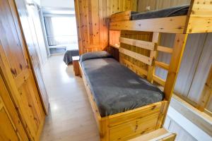 a couple of bunk beds in a wooden room at Res. Marilleva 1400 Apt.Solandra in Mezzana