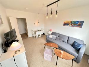 a living room with a couch and a table at Ferienwohnung-20-A139 in Westerland
