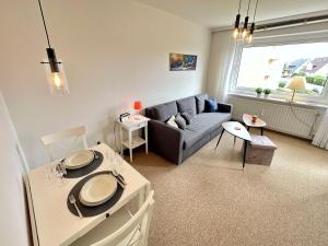 a living room with a couch and a table at Ferienwohnung-20-A139 in Westerland