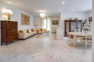 a living room with a couch and a table at Villa Alberta With Reserved Beach Spot in Marina di Massa