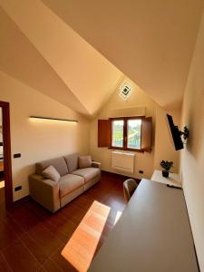 a living room with a couch and a table at Villa Vittoria Relais in Venosa