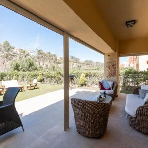 a patio with a table and chairs and a view at Marassi Stand alone luxury villa in El Alamein