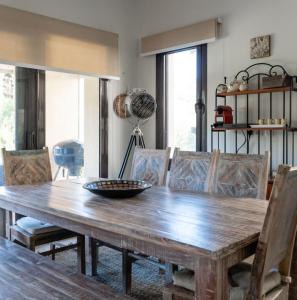 a dining room with a wooden table and chairs at Marassi Stand alone luxury villa in El Alamein