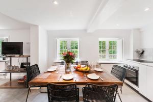 a dining room with a wooden table and chairs at Carolinenhof-2 in Tinnum