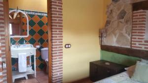 a room with a bathroom with a sink and a toilet at Casa El Pajar De Tasio in San Miguel del Pino +20 photos