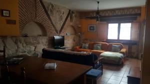a living room with a couch and a table at Casa El Pajar De Tasio in San Miguel del Pino