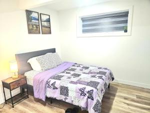 a small bedroom with a bed and a window at Snug 2 bedroom sleeps 5-Netflix in Edmonton
