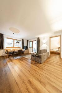 a living room with a couch and a table at Pension Hofer in Brunico