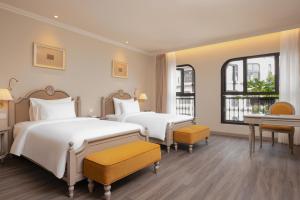 a hotel room with two beds and a piano at Hotel Montmartre de Sapa - Newly Opened April 2026 in Sapa