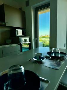 a kitchen with a table with two plates and a cup at Casa Clio in Noicattaro +45 photos