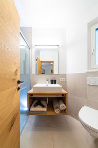 a bathroom with a sink and a mirror at Pension Hofer in Brunico +84 photos