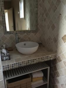 a bathroom with a sink and a mirror at Delaporte in Béziers