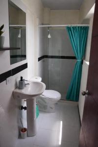 a bathroom with a sink and a toilet and a shower at Casa Esperanza in Cali +40 photos