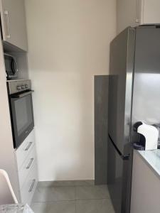 a kitchen with a stainless steel refrigerator in it at Lili's Sea View in Budva